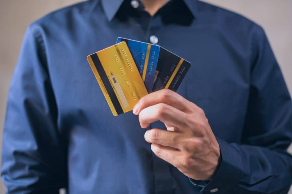 man holding credit cards